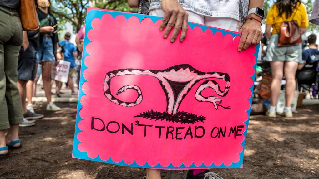 A protester holds a sign before a protest outside the Texas state capitol on May 29, 2021 in Austin, Texas.