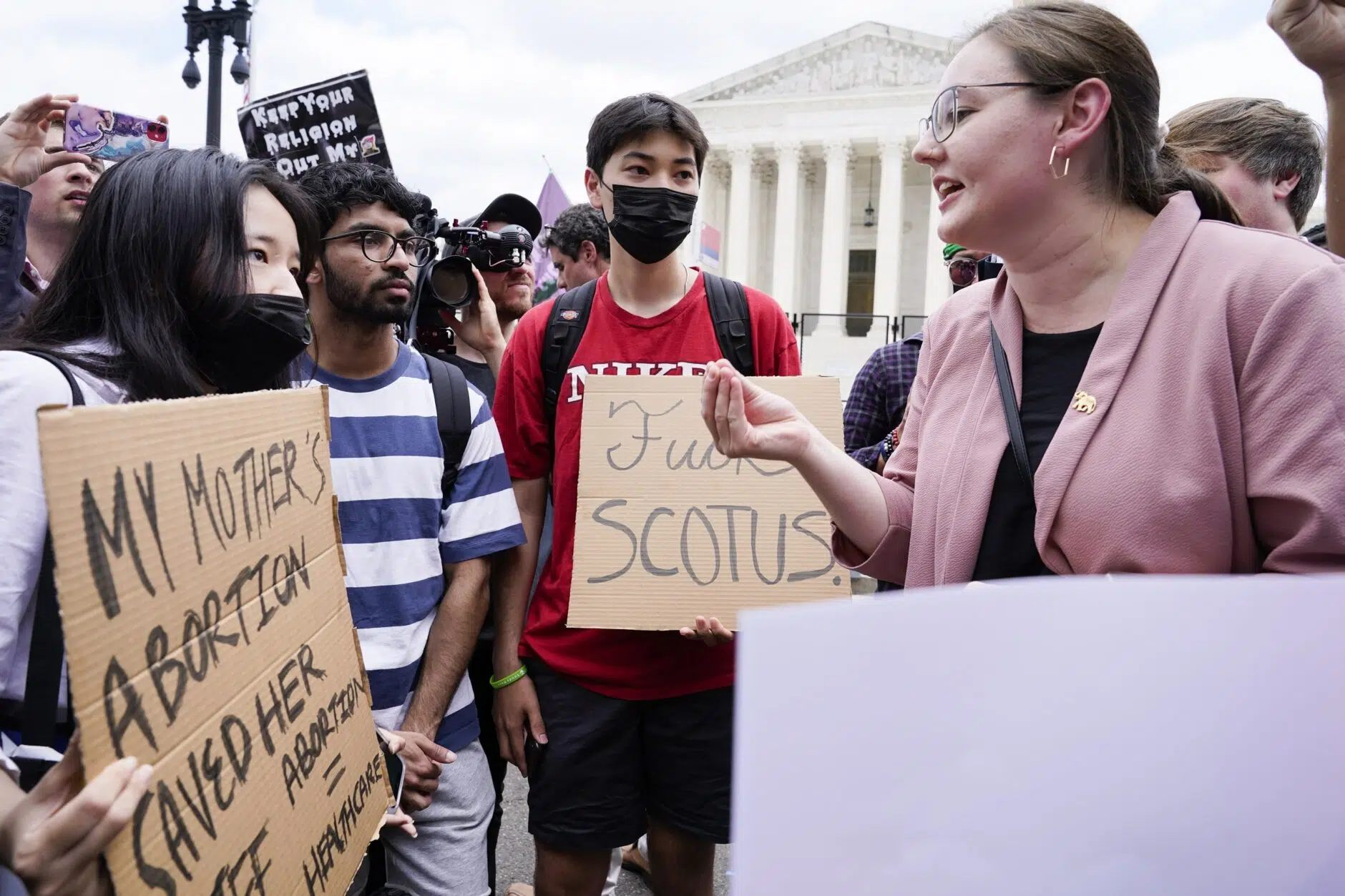 Abortion-rights activists, at left, confront anti-abortion activists, at right, following the Supreme Court's decision to overturn Roe v. Wade on Friday, June 24, 2022.